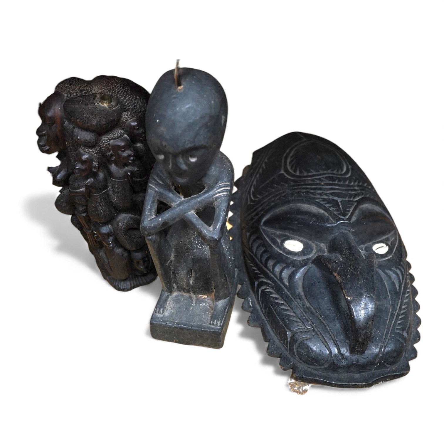 A Papa New Guinea mask and figural carving, together with an African carving converted to a lamp